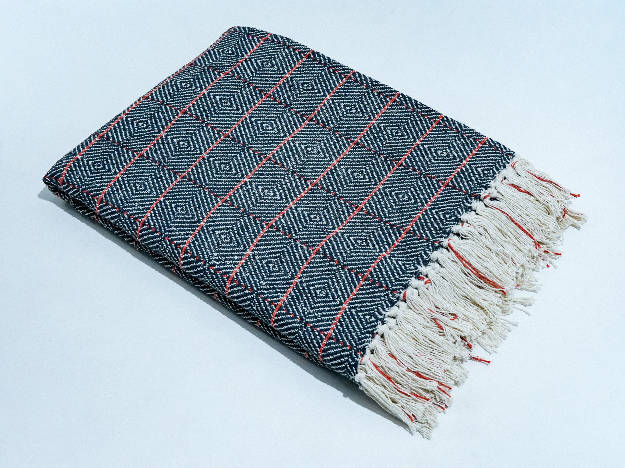 Cross Check Throw in black, STCT-139 E, styled in a living room setting