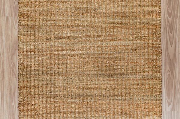 Rectangular and round handwoven jute rugs laid out for wholesale assortment comparison