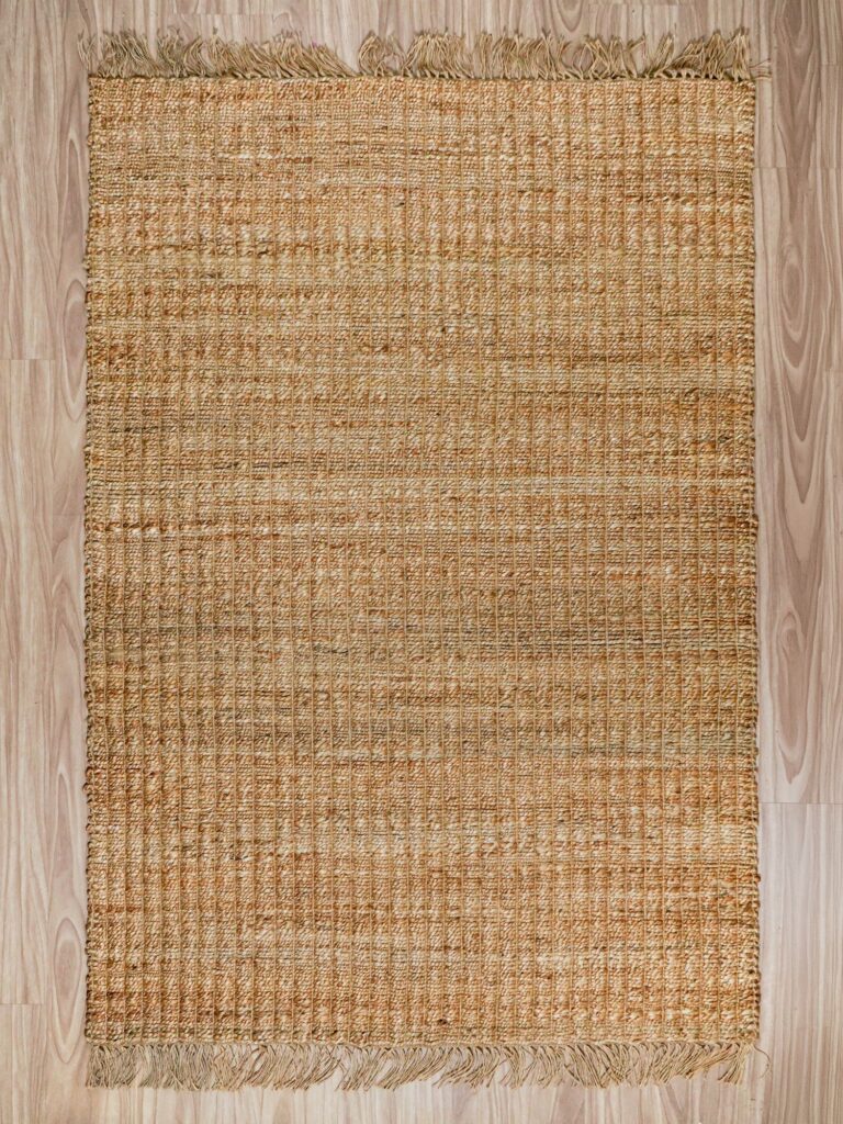 Rectangular and round handwoven jute rugs laid out for wholesale assortment comparison