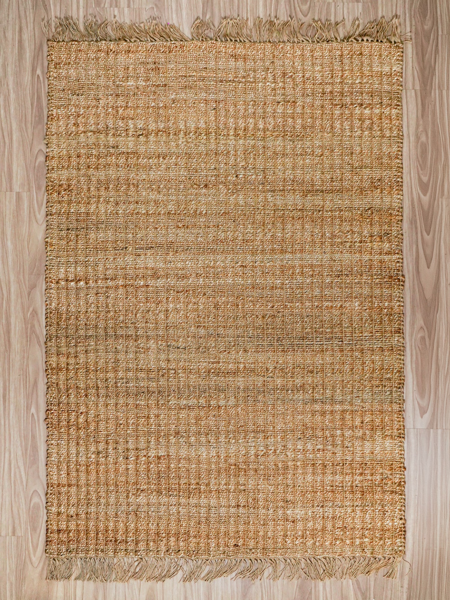 Rectangular and round handwoven jute rugs laid out for wholesale assortment comparison