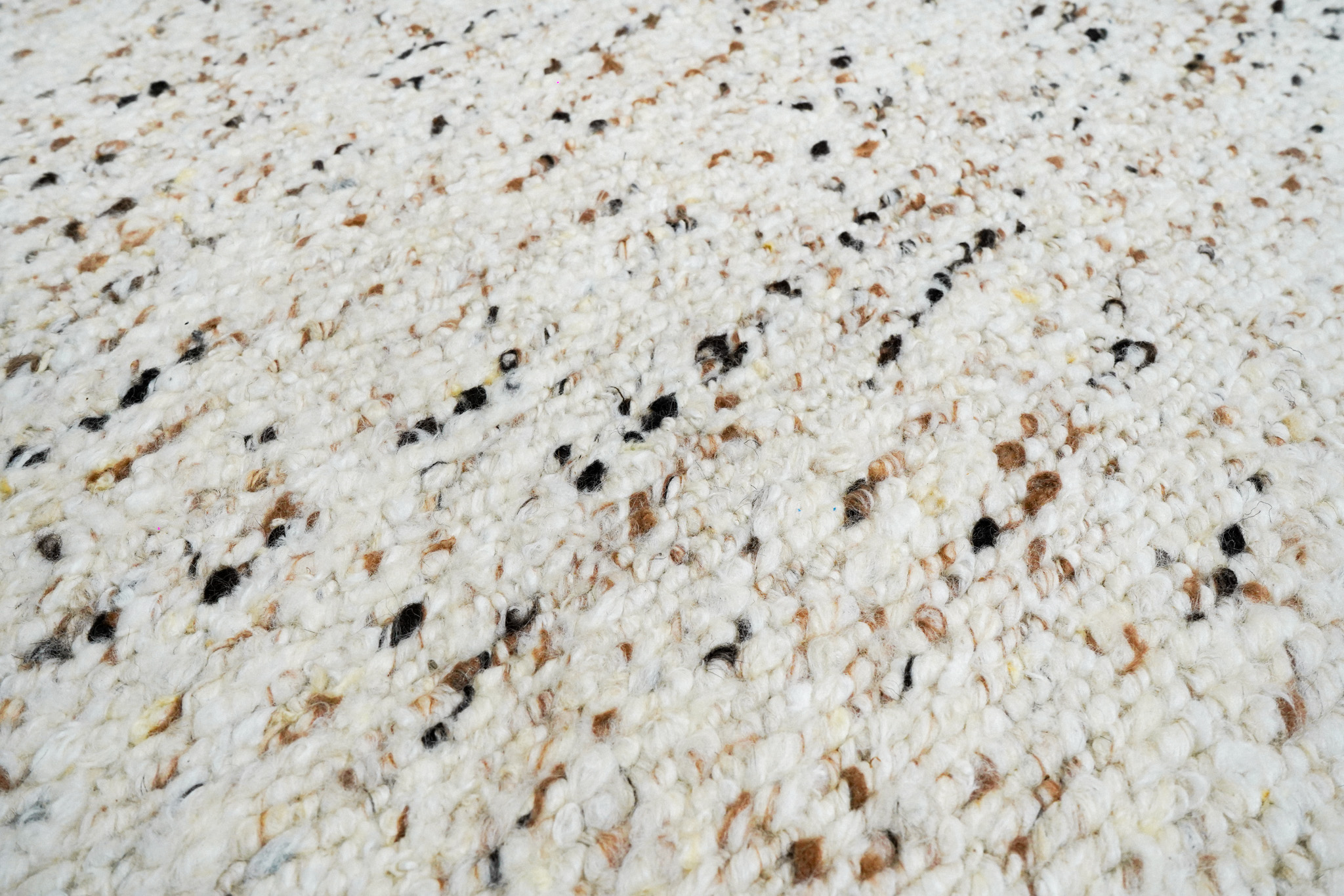 Close-up of the handwoven weave on handcarded wool rug AWD2604