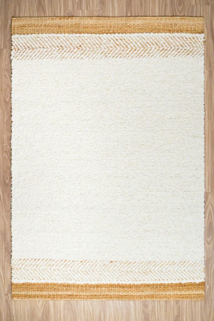 Handcarded wool rug AWD2603 IV in marled ivory tones, studio shot on white background