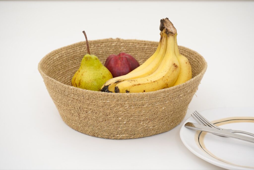 Handwoven basket styled in a room, made in India for wholesale