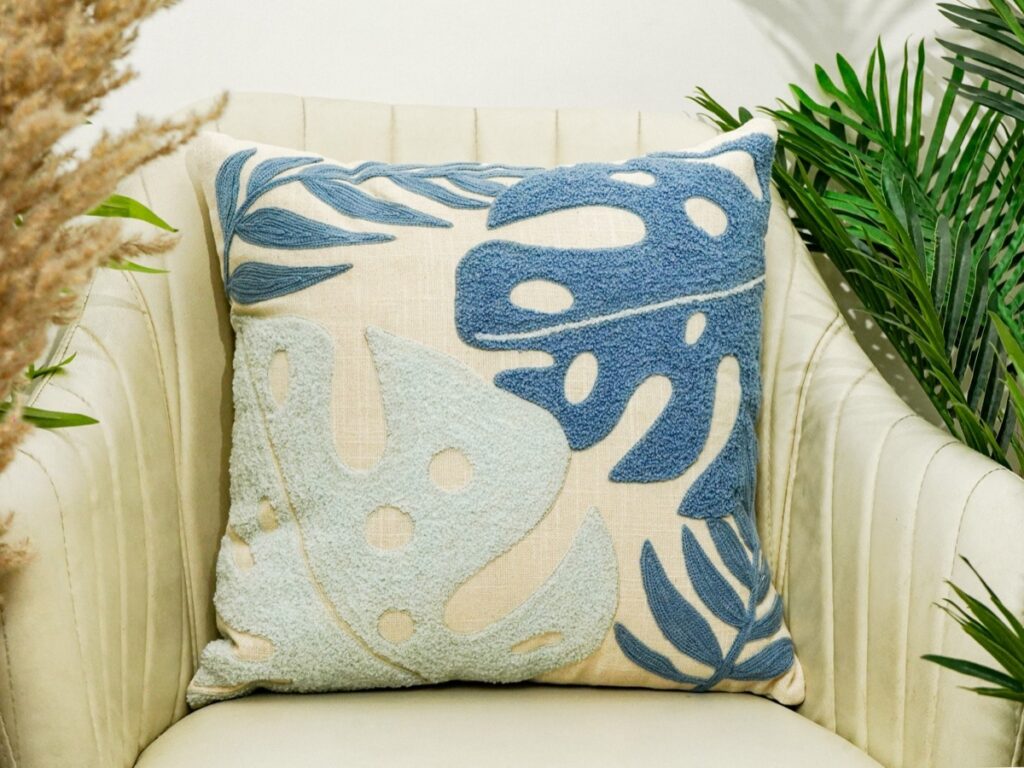 Cream handwoven cushion with fringe detail on a sofa