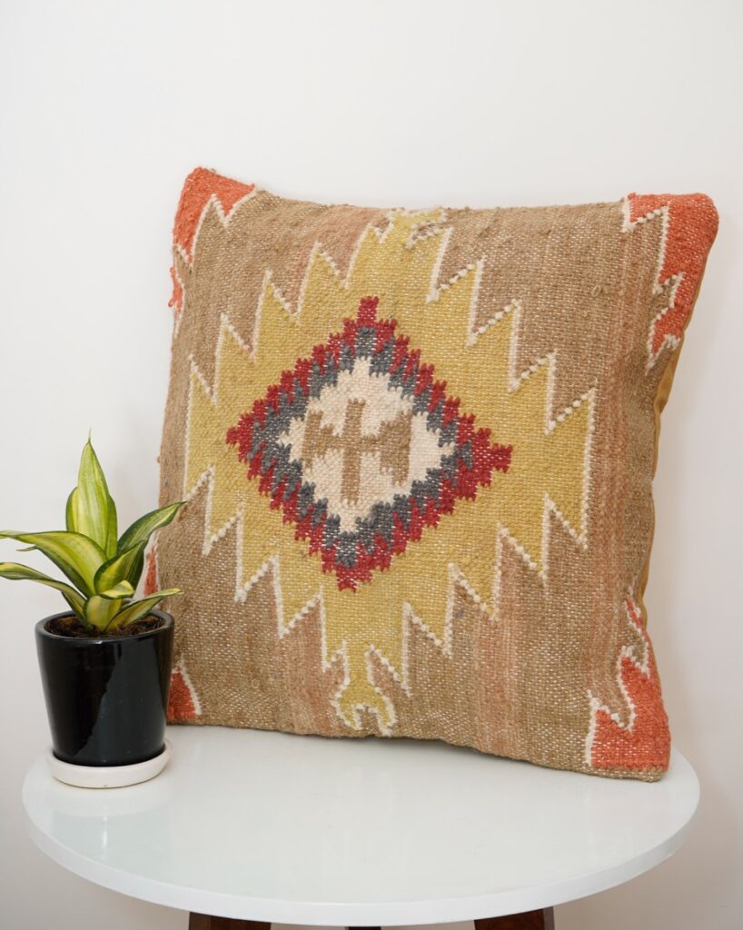 Handmade cushion styled on a sofa, made in India for wholesale