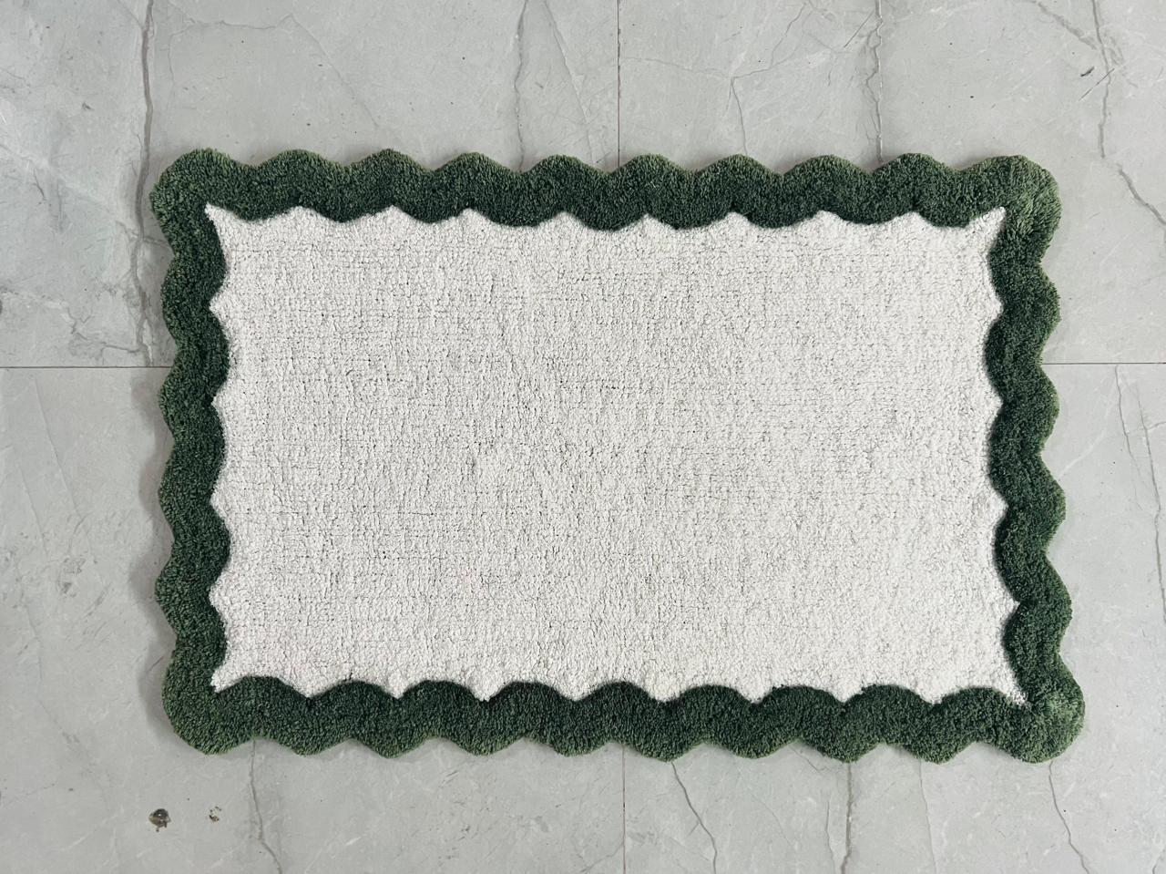 Scallop pattern printed cotton bath mat in indigo-grey colourway, studio shot on white background