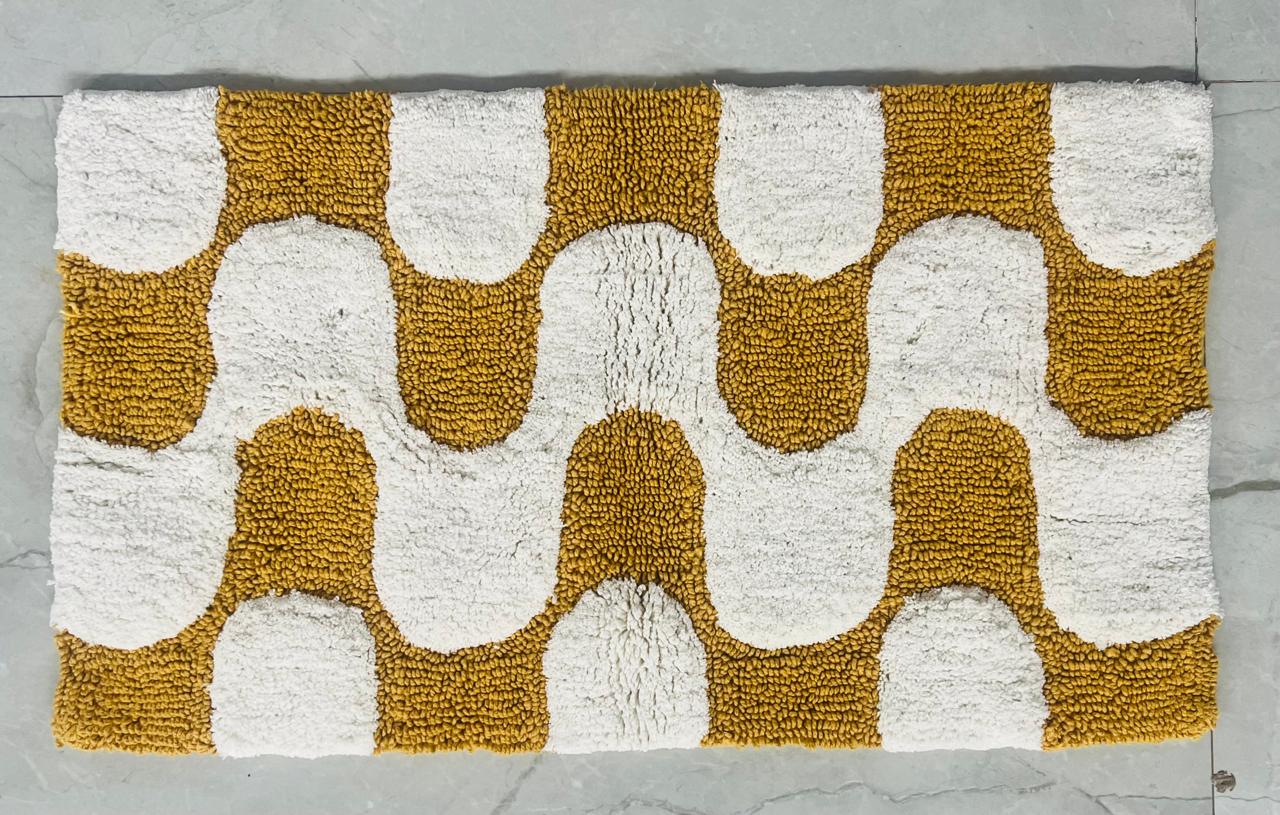 Arch pattern printed cotton bath mat in mustard-sand colourway, studio shot on white background