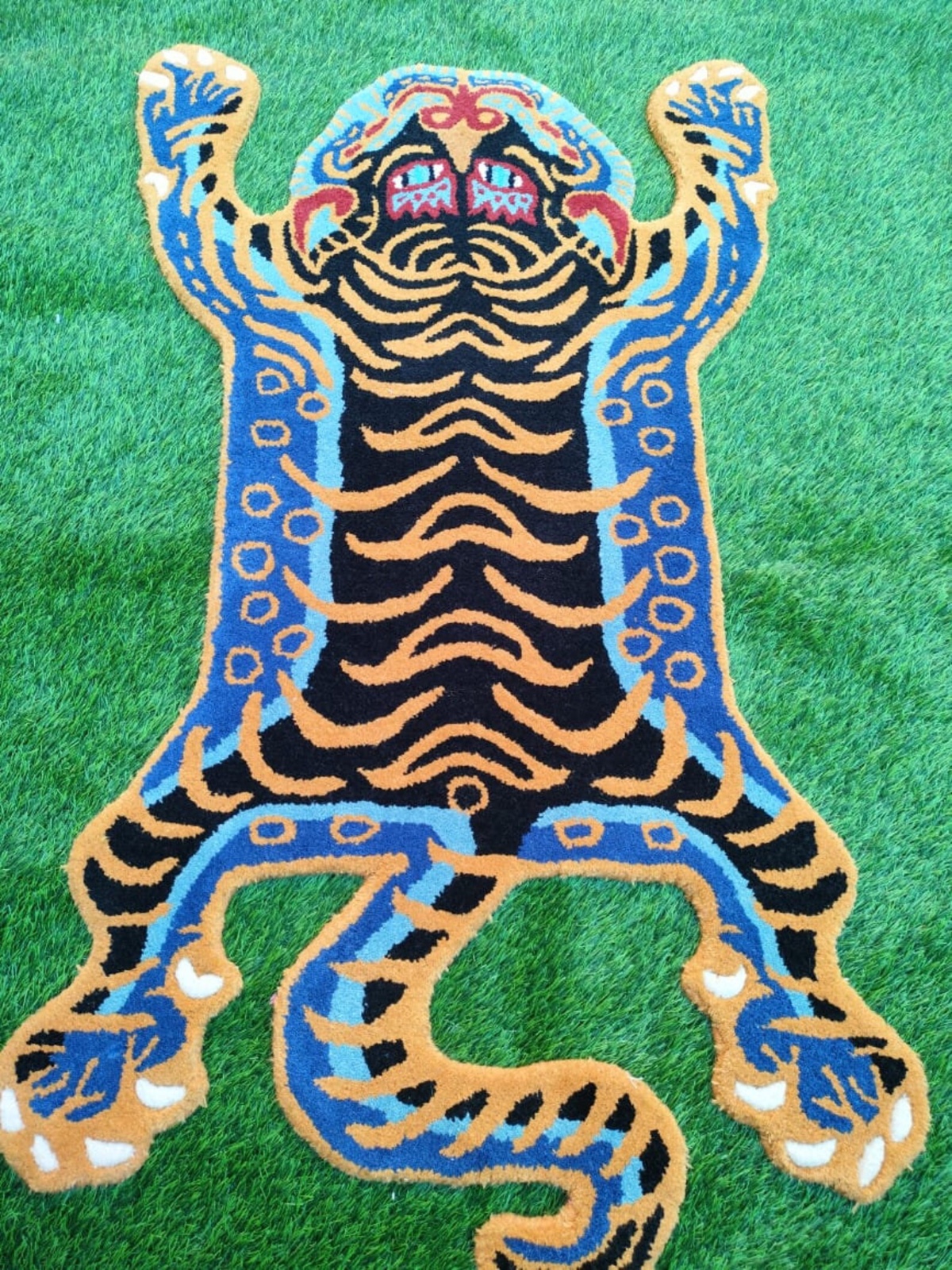 Close-up of hand-tufted wool pile weave on the Tibetan Tiger Folk Carpet FCA-26005