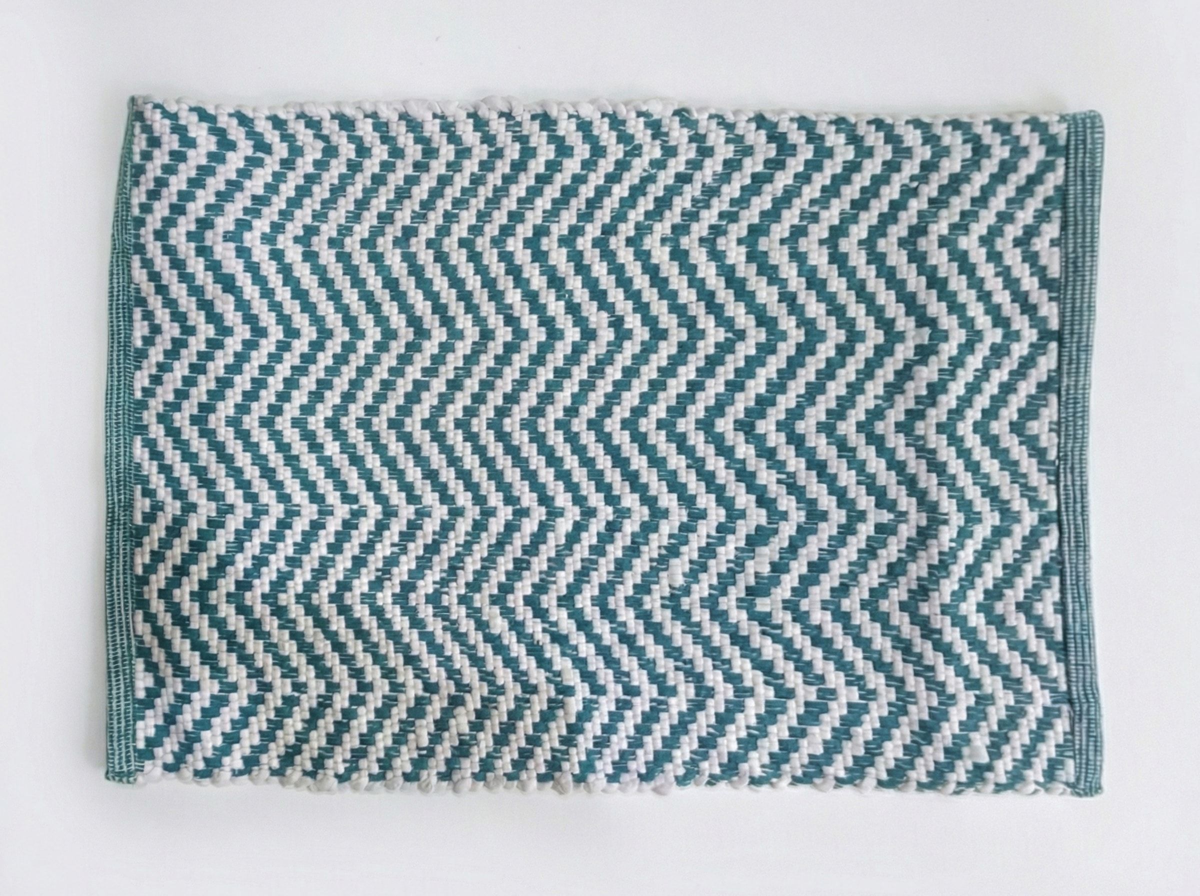 Chunky five-strand braided rug displayed in a retail setting
