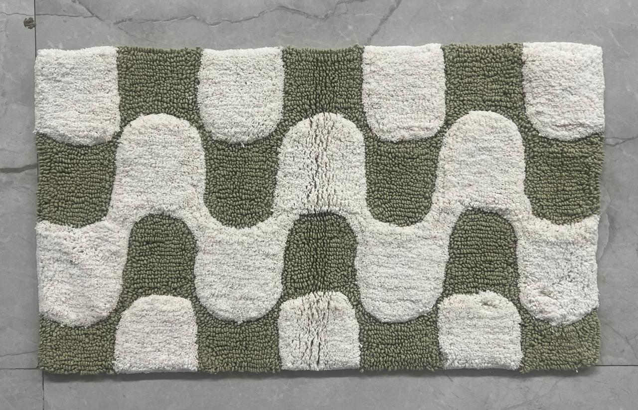 Arch pattern printed cotton bath mat in green colourway, studio shot on white background