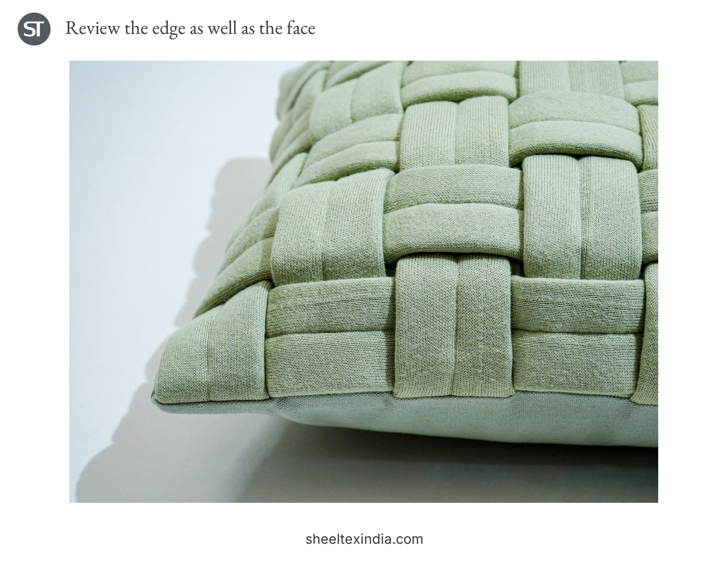 Close view of pale green interlaced fabric bands meeting the cushion edge, with plain fabric visible below.