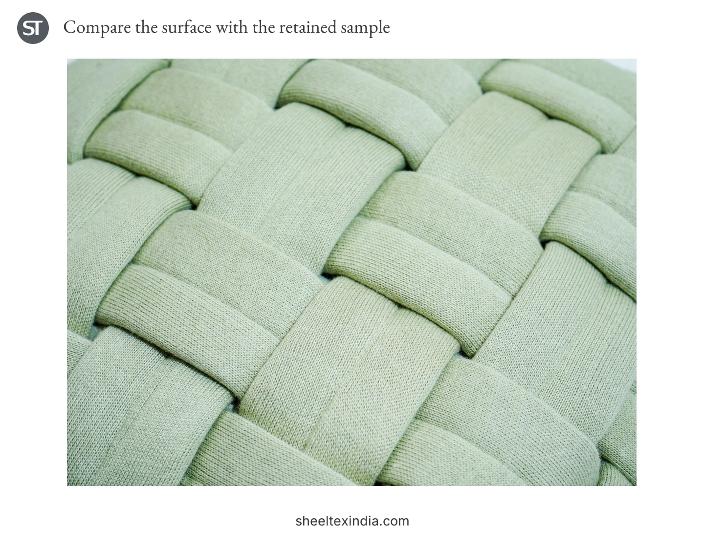 Close-up of pale green fabric bands passing over and under each other across a cushion surface.