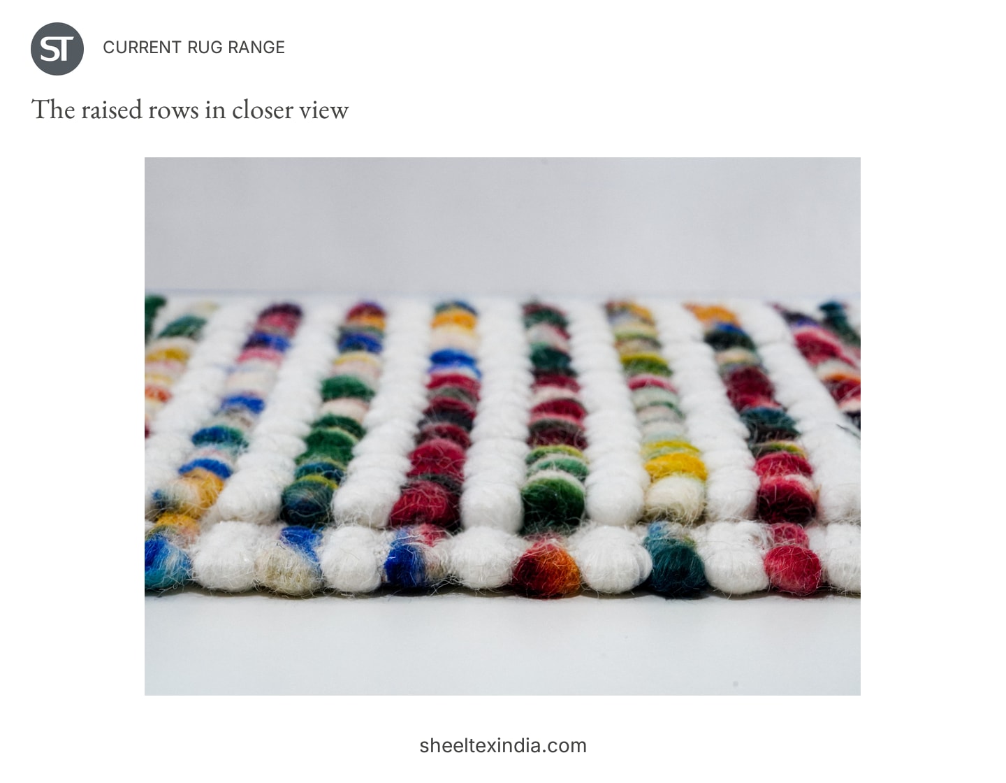 Low-angle detail of a rug sample showing raised white rows between rows of bright colour.